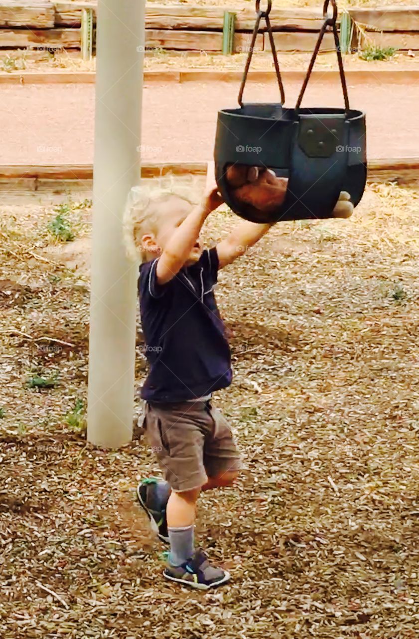 This little boy wanted to give his friend George a turn doing his favorite things- riding in the swing. He would go to the park every day if he could.