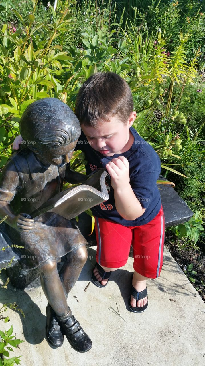 Boy holding a metal statue