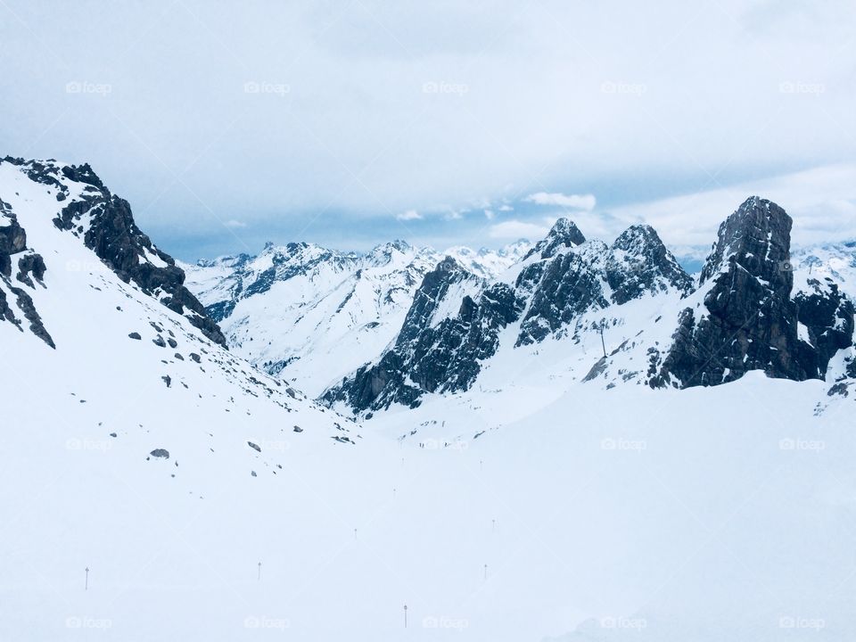 A view to the Alps on a cloudy and snowy day 