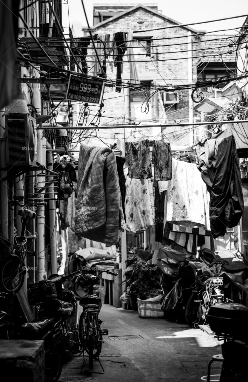 Asia china Beijing old town laundry day clothes for drying hang outside siede road black and white