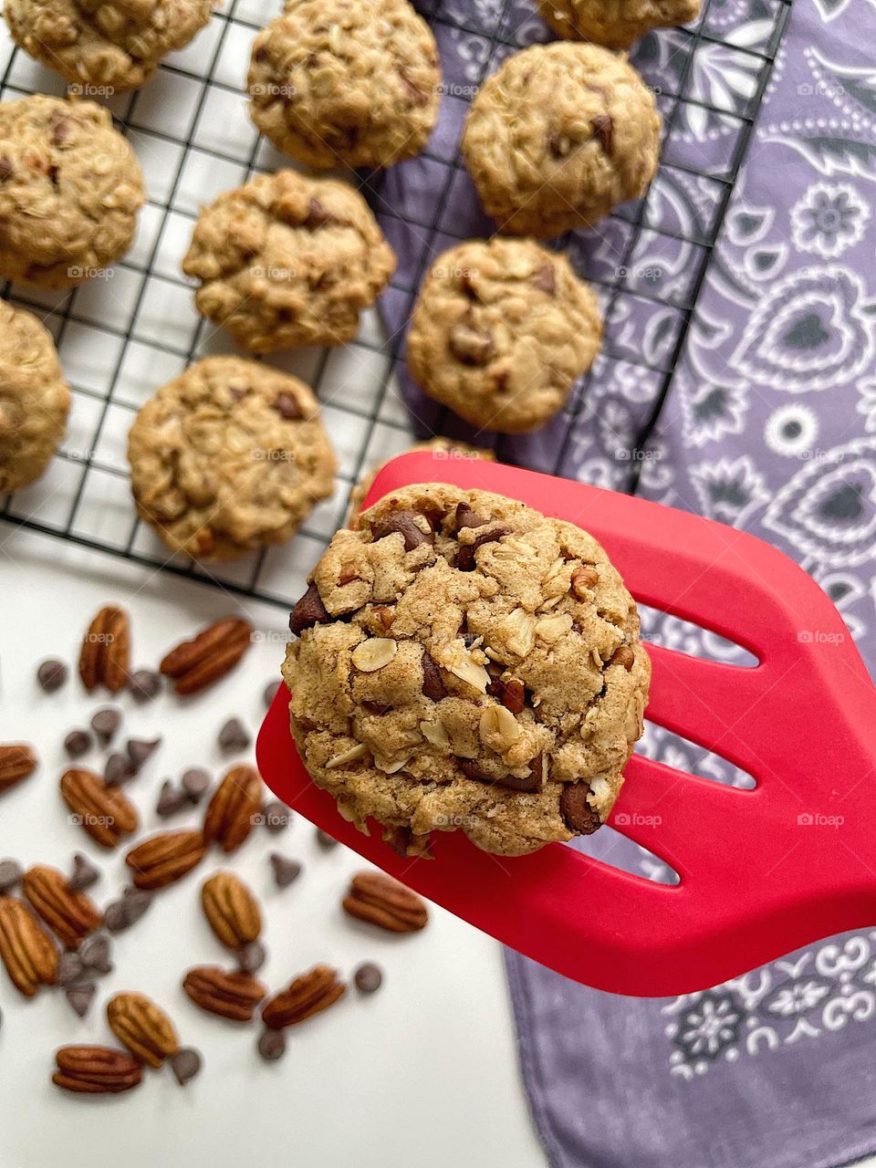 Baking Cowboy Cookies at home, making homemade cookies, cookie on a spatula, placing cookies on a cooling rack, freshly baked Cowboy Cookies 