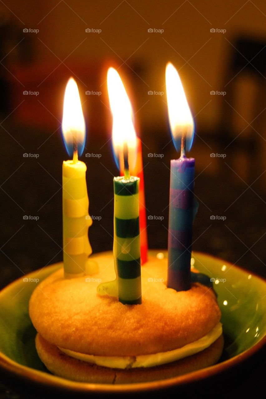 4 birthday candles on mini cake