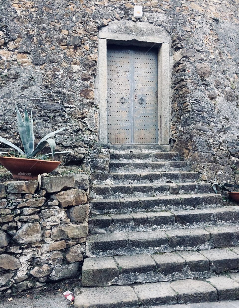 Stairs to the iron doors of an old church