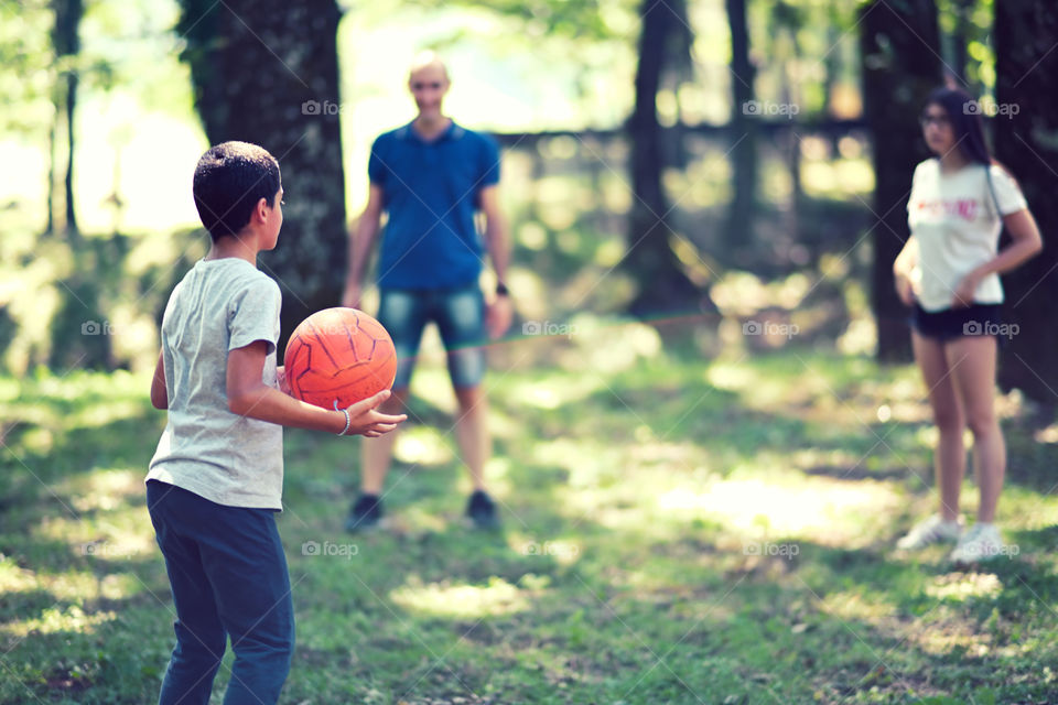 child playing ball in the woods