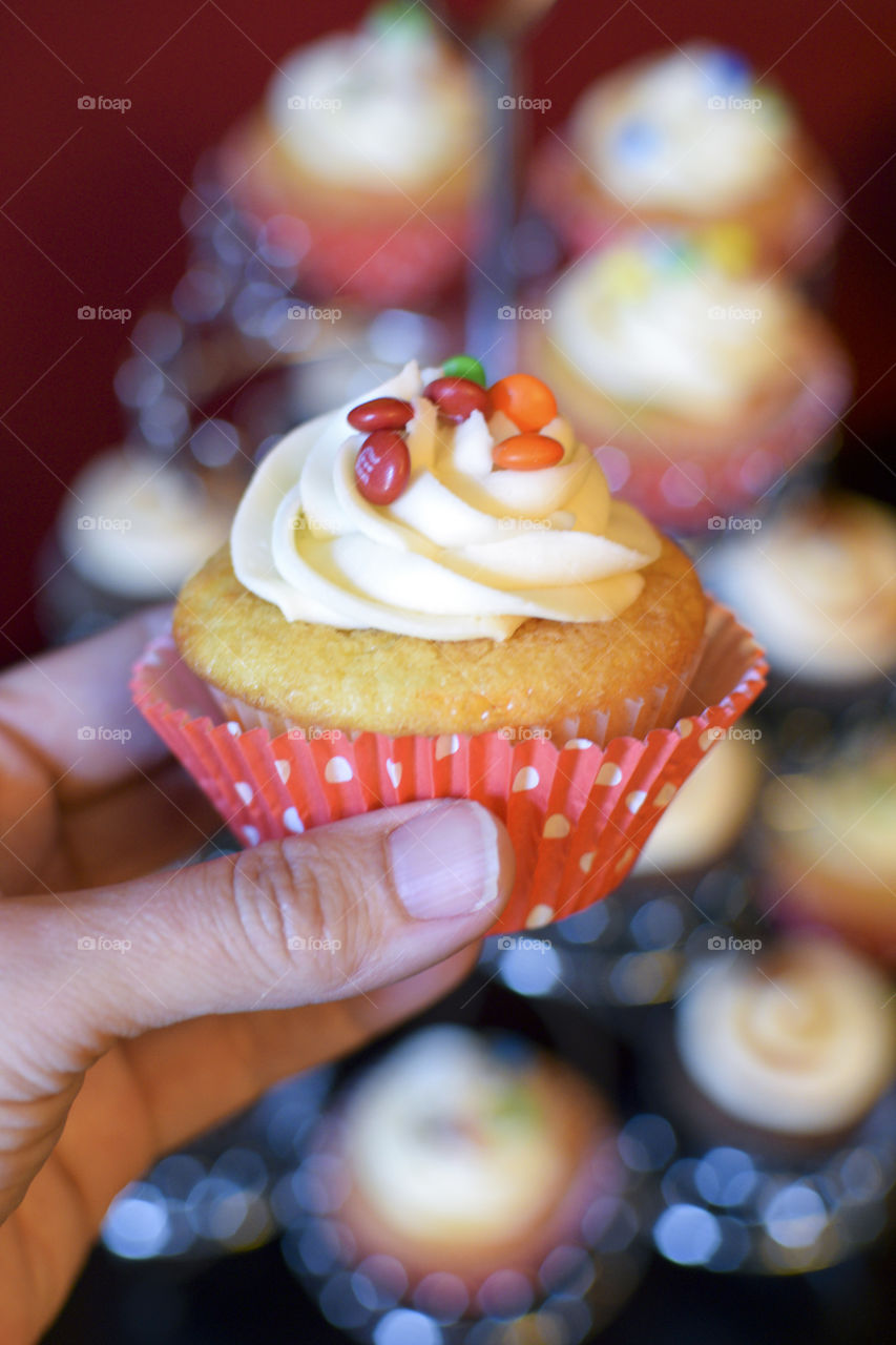 Person holding cupcake in hand