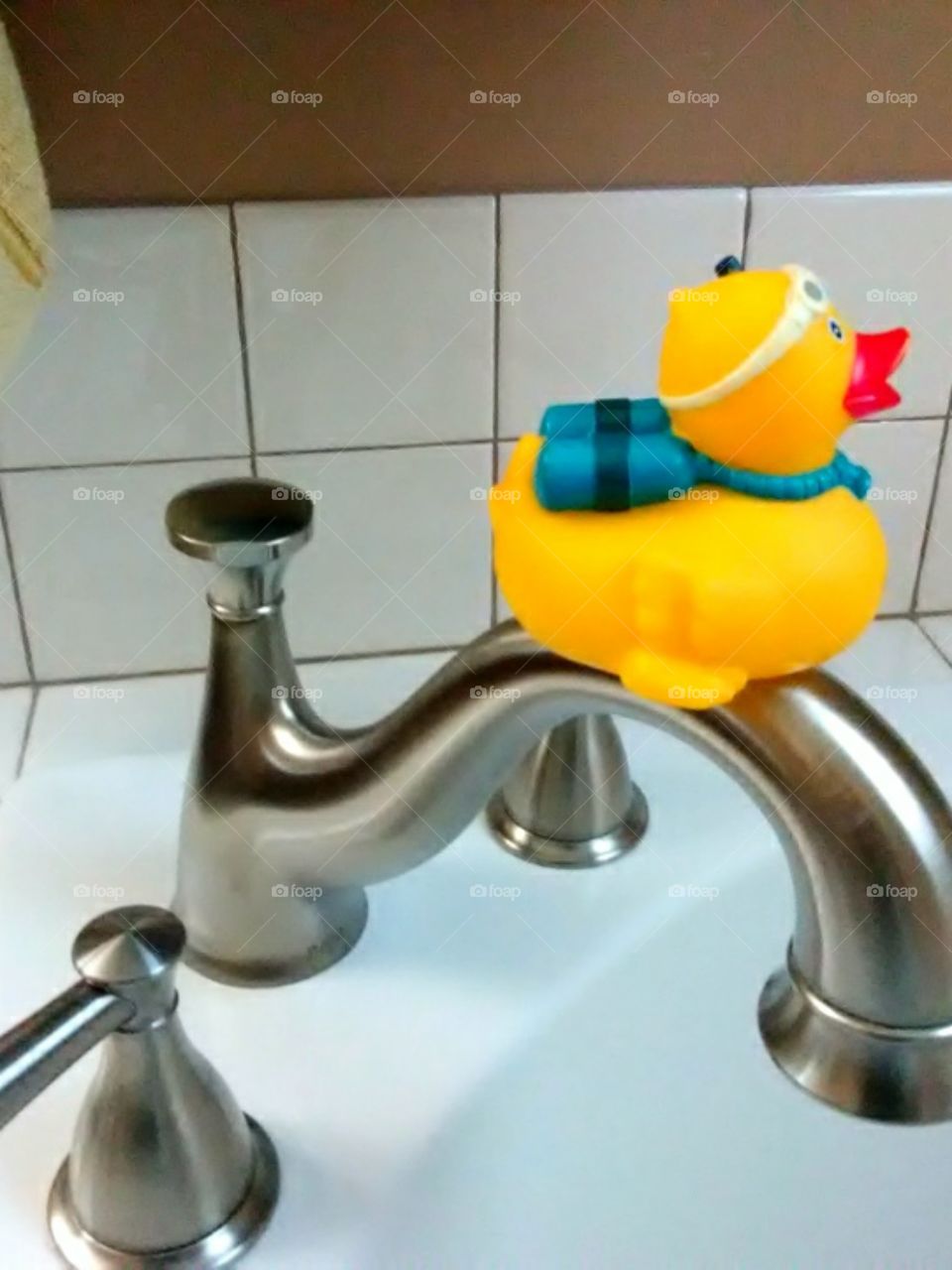 Rubber Ducky on Tub Faucet