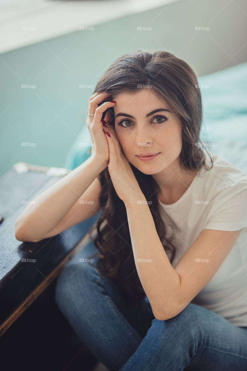 Beautiful young woman at home in daylight 