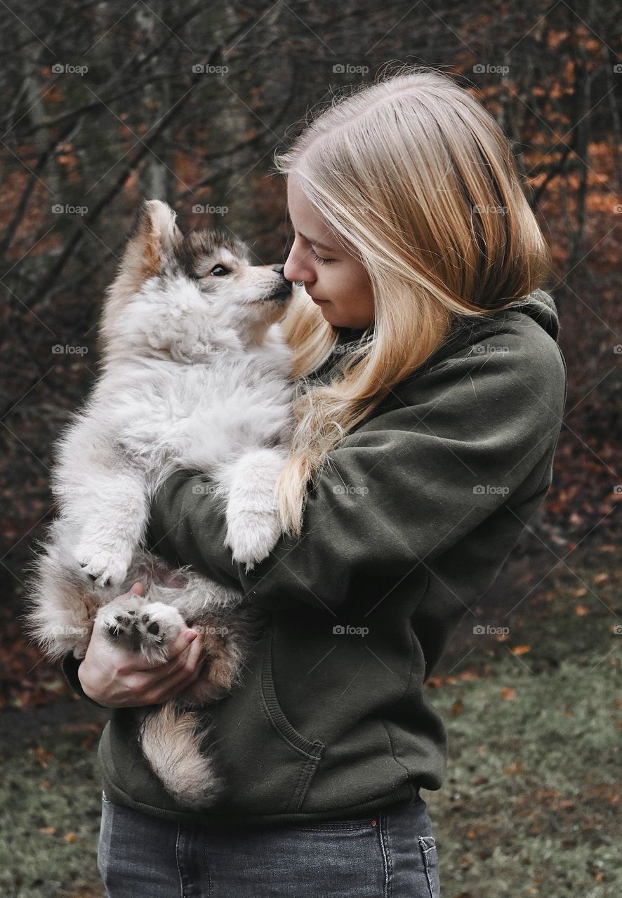 Blonde girl and Finnish Lapphund puppy