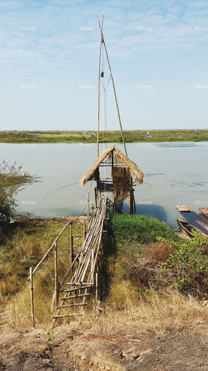 A little hut extends into the swamp.
