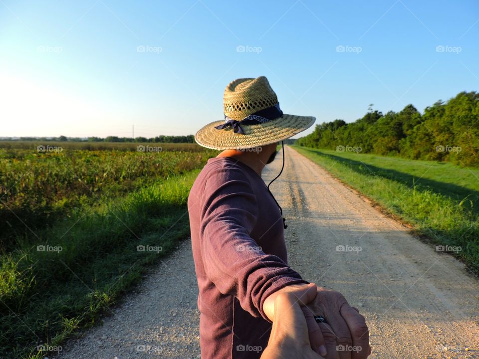 Take my lead. Hiking on a cattail marsh trail 