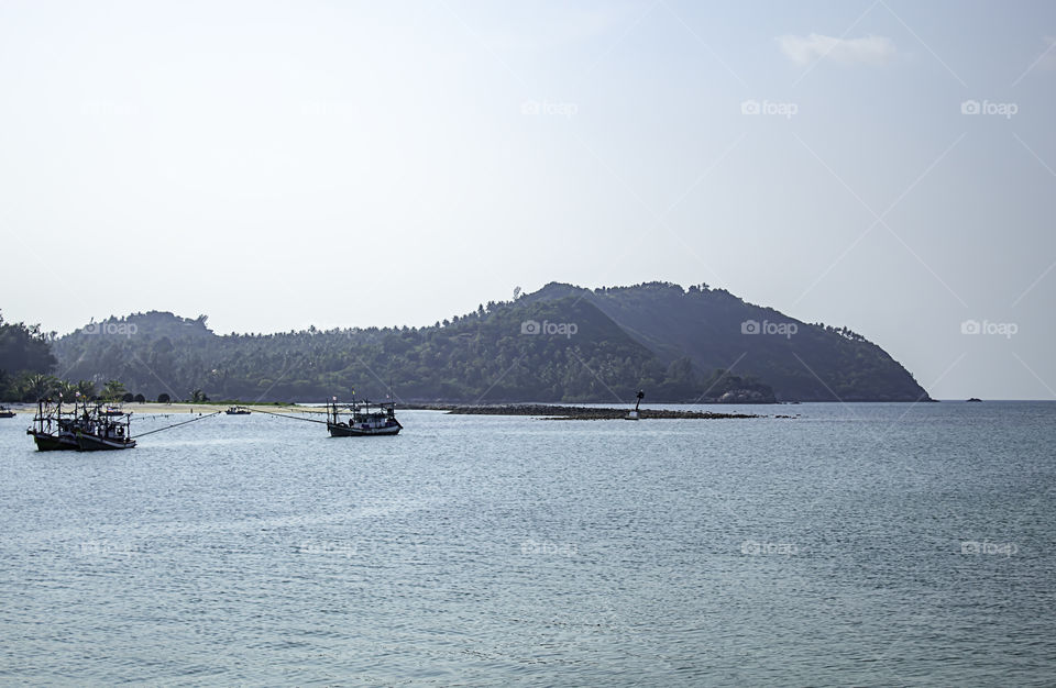 Fishing boats parked on the Beach at Koh Phangan, Surat Thani in Thailand.