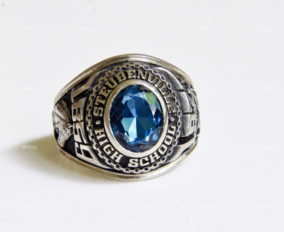 Class ring with blue stone and white gold band