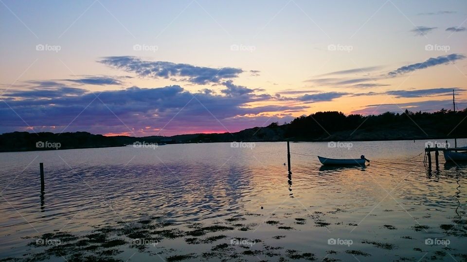 View of sailboat moored in sea at sunset