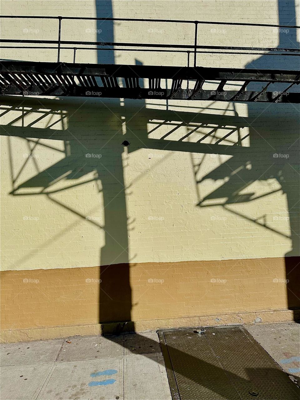 Sometimes the shadows cast by objects in the late afternoon sun assemble to the most exquisite mix of patterns and shapes as is the case here on this facade on “Jefferson St” off “Broadway” in “Bushwick”, Bklyn. 2024. Hypnotic Productions