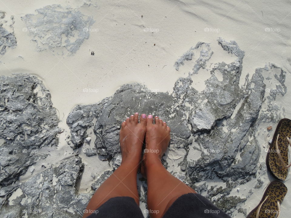 Tan legs and white sand.