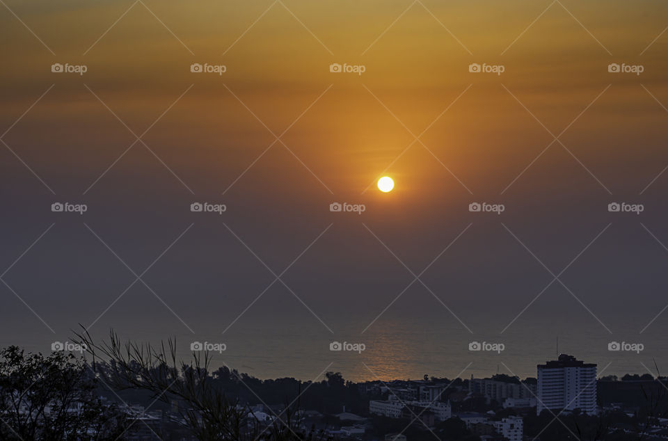 The morning sun light reflects the sea Behind the cityscape at Hua Hin, Prachuab khiri Khan in Thailand.