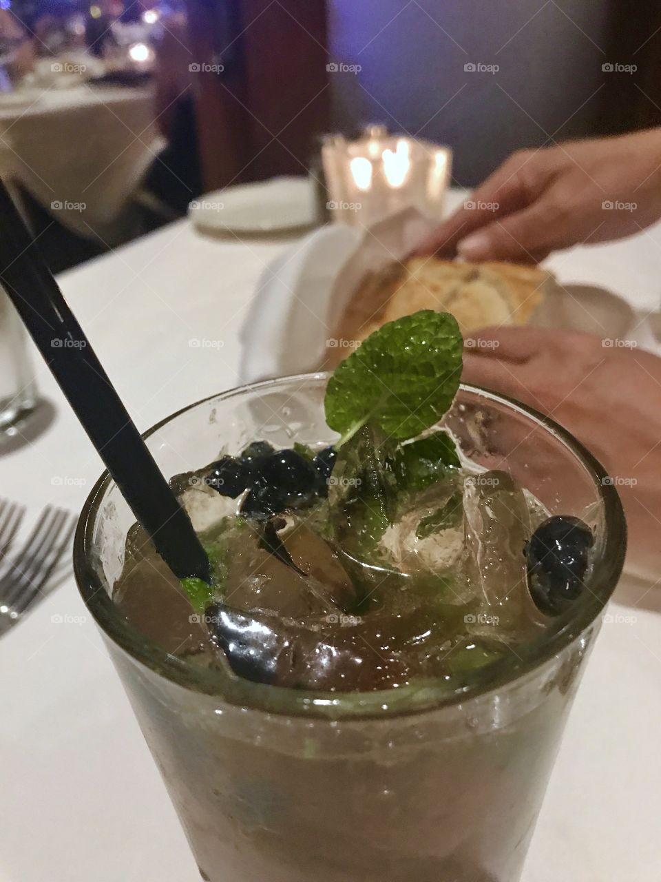 Delicious fresh herb cocktail with mint and blueberries while fine dining at a luxury hotel restaurant, Kirby’s Steak house!