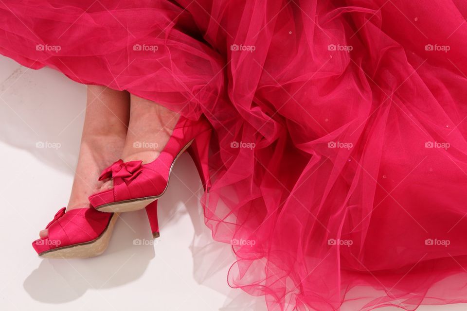 Woman's red shoes on red dress