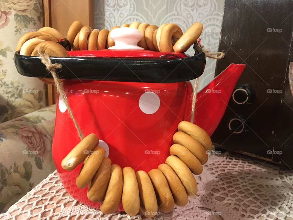 Vintage red color tea pot with national Russian bagels. Kitchen decoration. Kitchen background. 