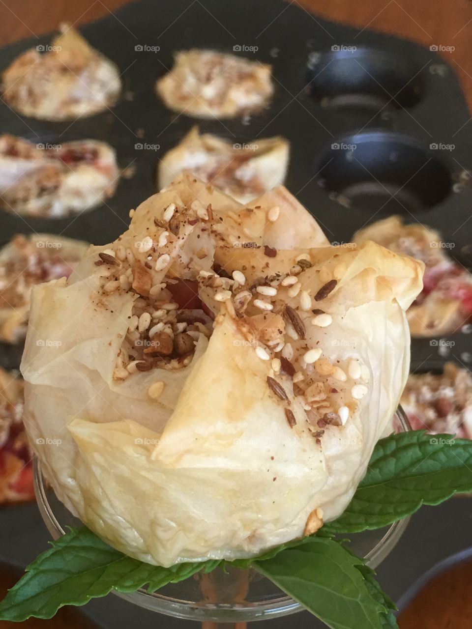 Homemade FILO Pastry savoury tart using chopped beers, feta cheese, mint, onions, and topped with dukkah spice 