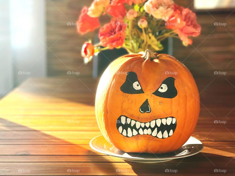 Halloween moody pumpkin on the table 
