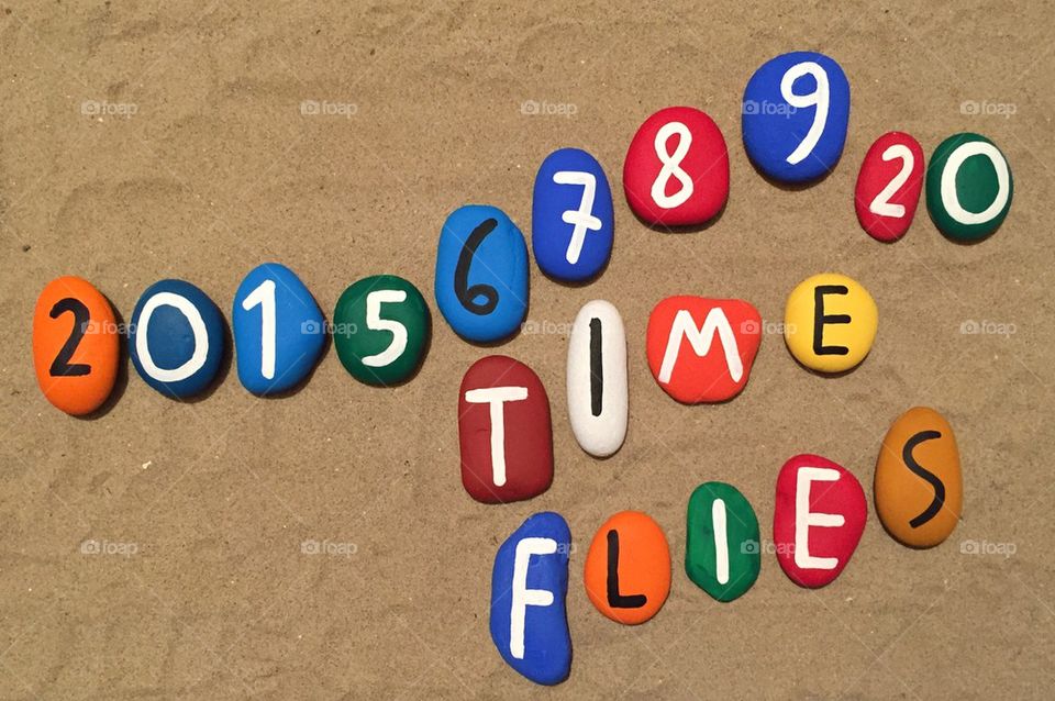 Time flies, concept of time on colored stones 