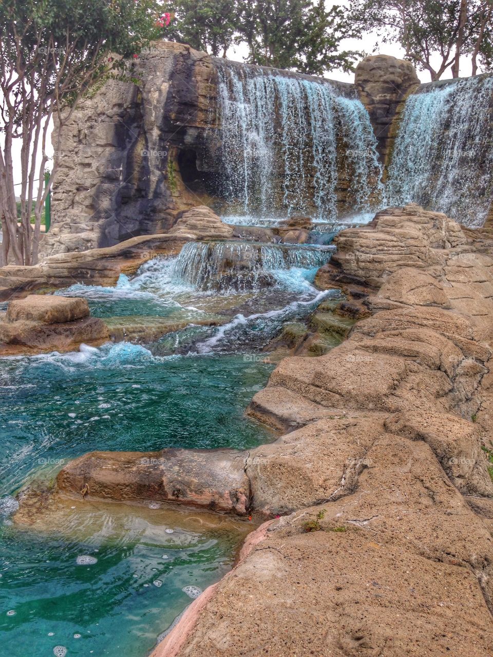 Pool of blue. Waterfall at mini golf course