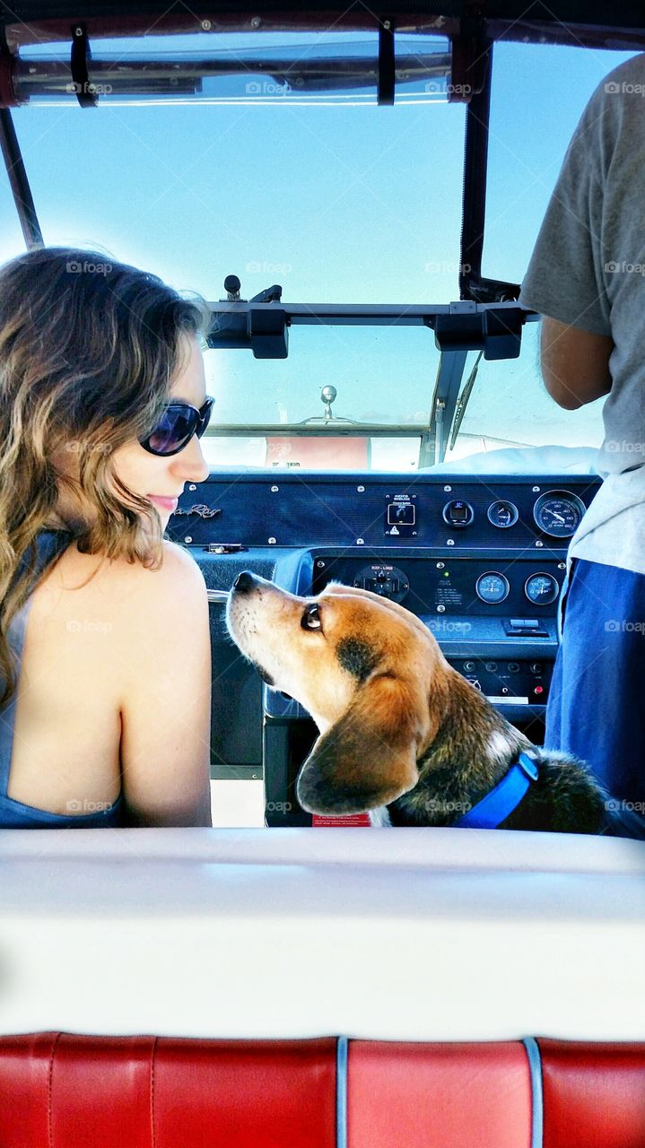 A Girl on the boat with her beagle dog. best friends forever enjoying the great outdoors!