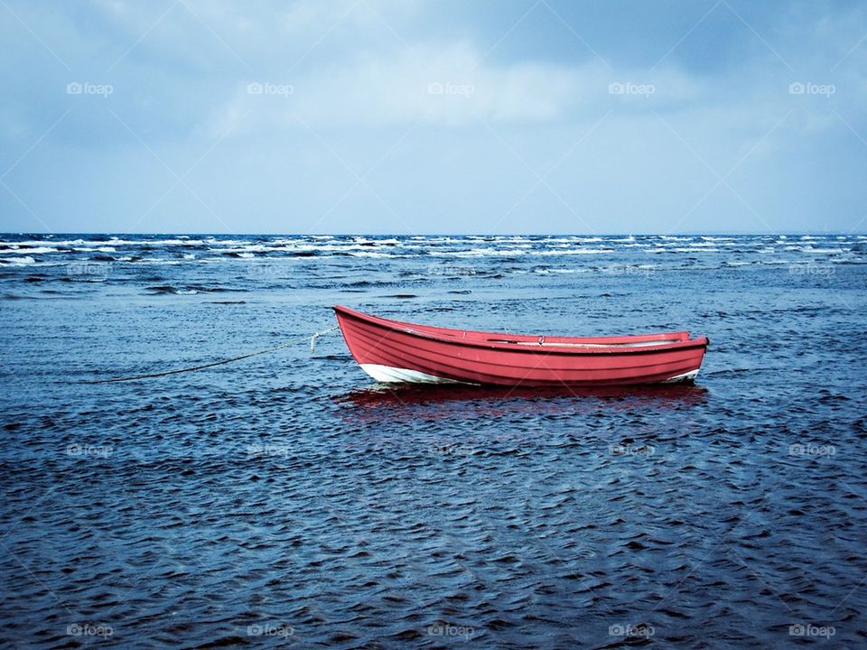 Red boat in the blue sea