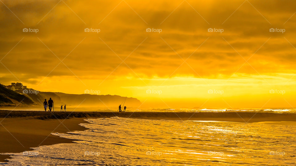 People on the beach during golden hour