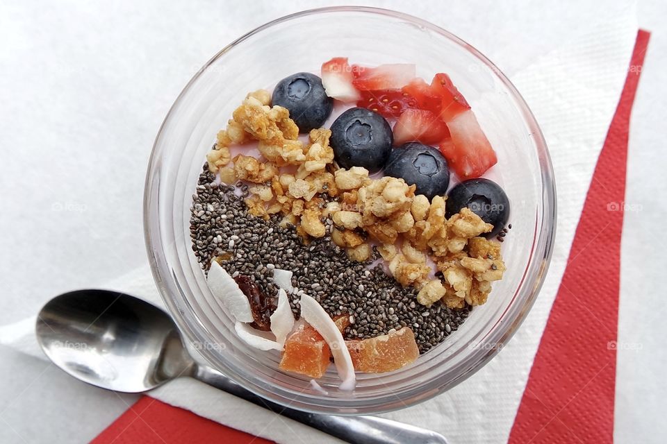 Fresh smoothie in bowl with blueberry and strawberry