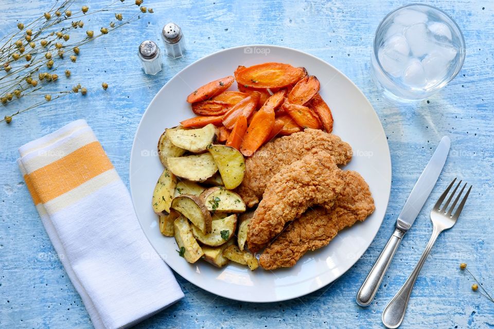 Chicken potatoes and carrots on a plate 