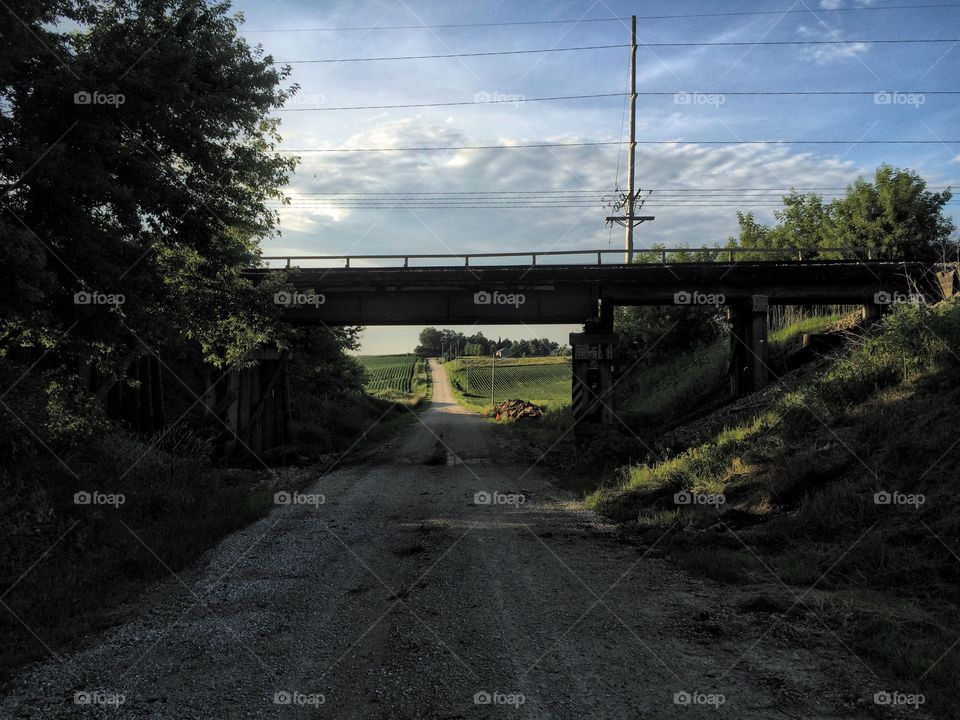 Railroad overpass over rural gravel road