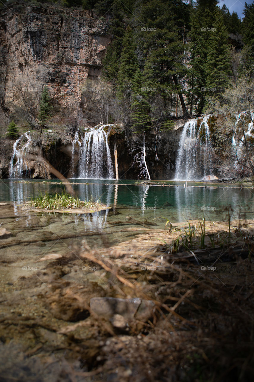 Beautiful crystal clear water flowing from a waterfall into a Colorado lake high in the mountains. 