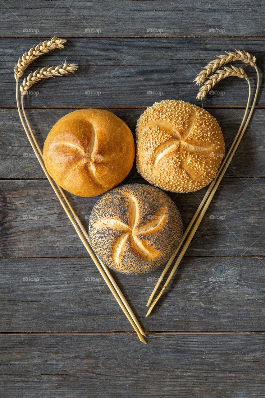 three buns with poppy and sesame seeds