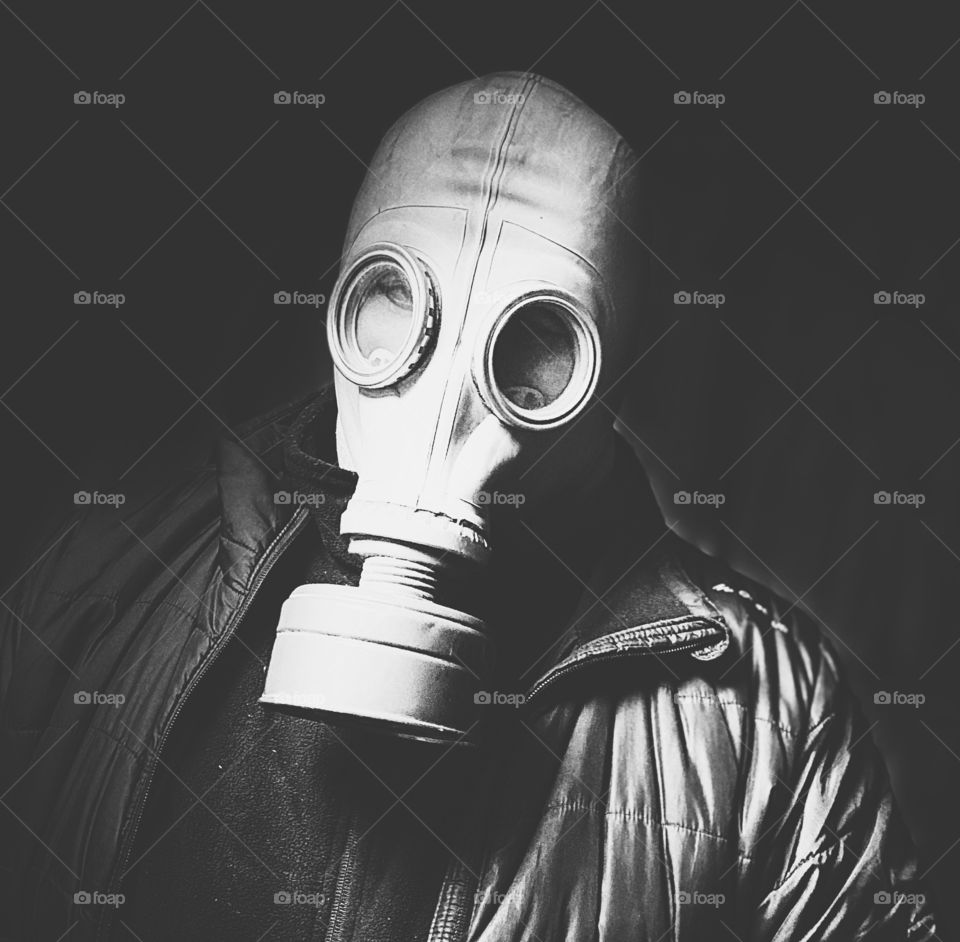 Black and white portrait of a man in a gas mask