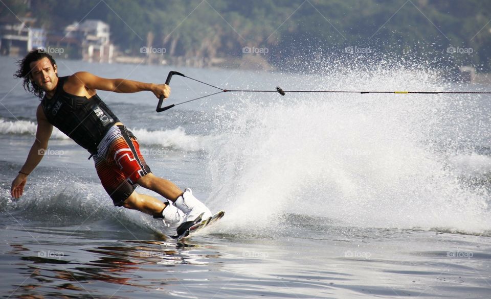 Young man water skiing on a European lake