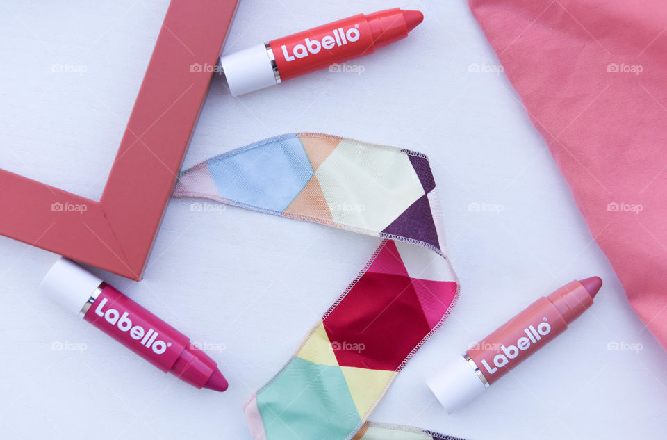 Labello lip crayons surrounded by similar bright color tones