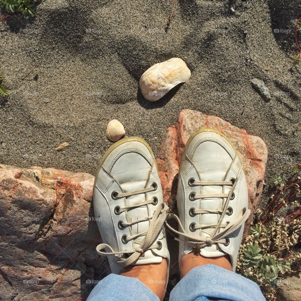 Me standing on a stone on the beach