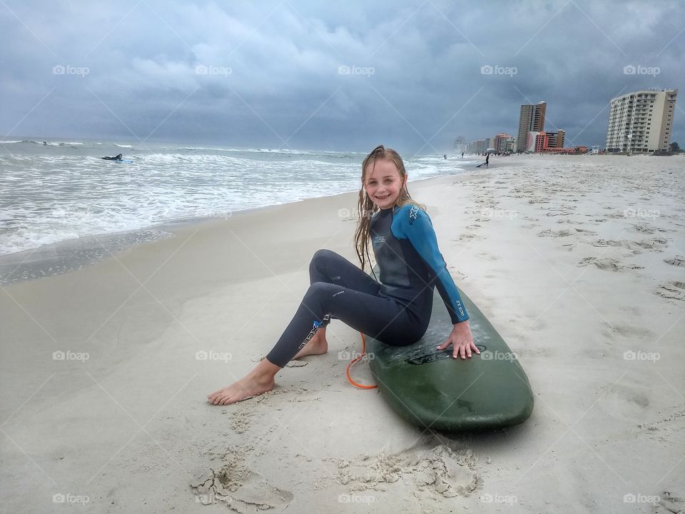 Young teen girl on surfboard