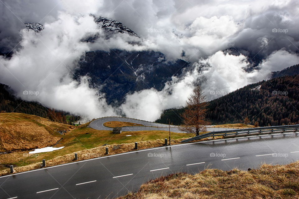 View of road by mountain against sky