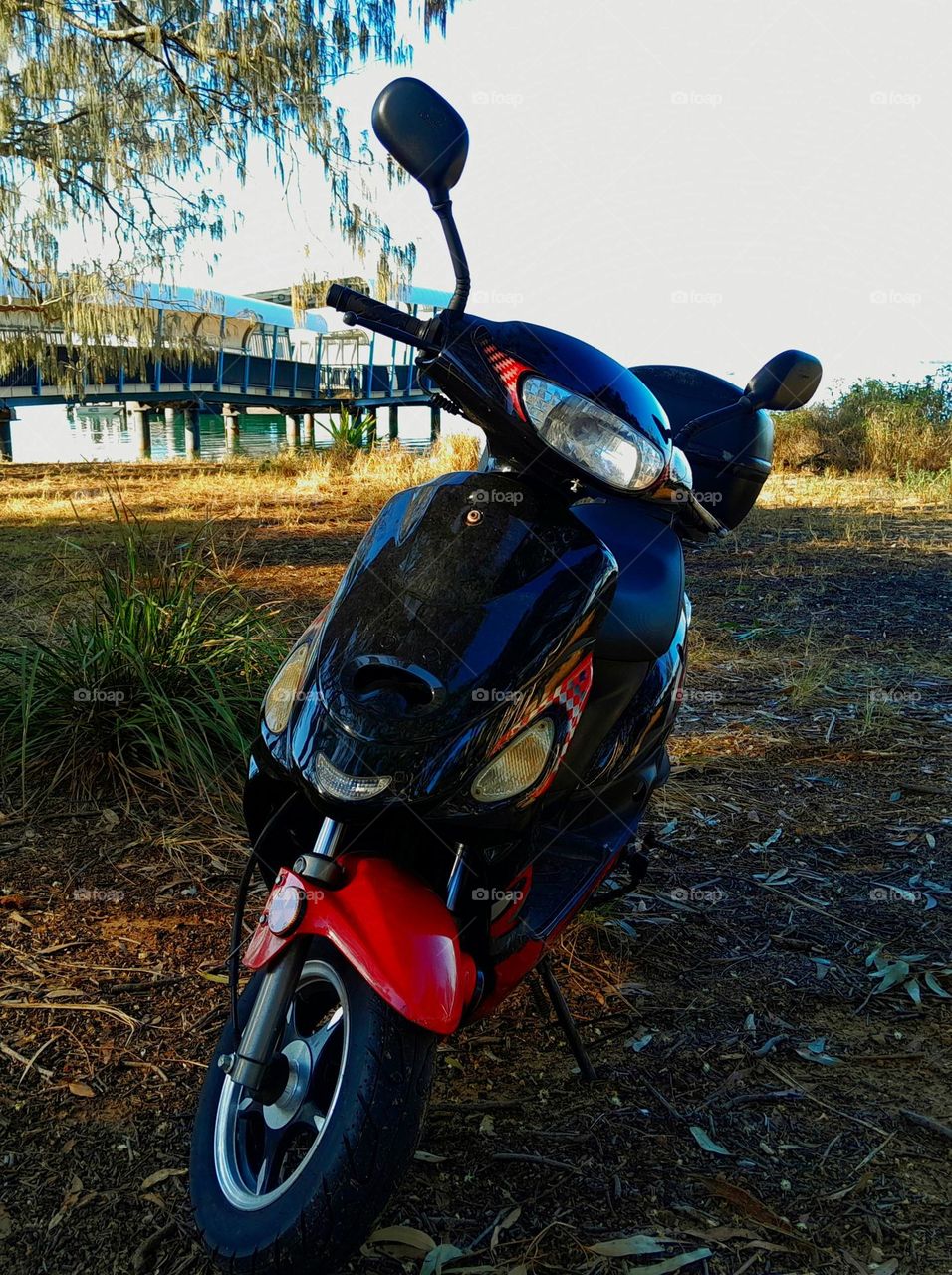Scooter Parked on Beach near Ferry