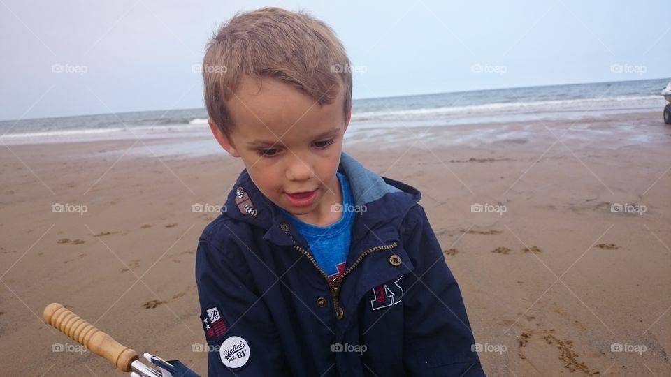 Boy playing on sandy beach