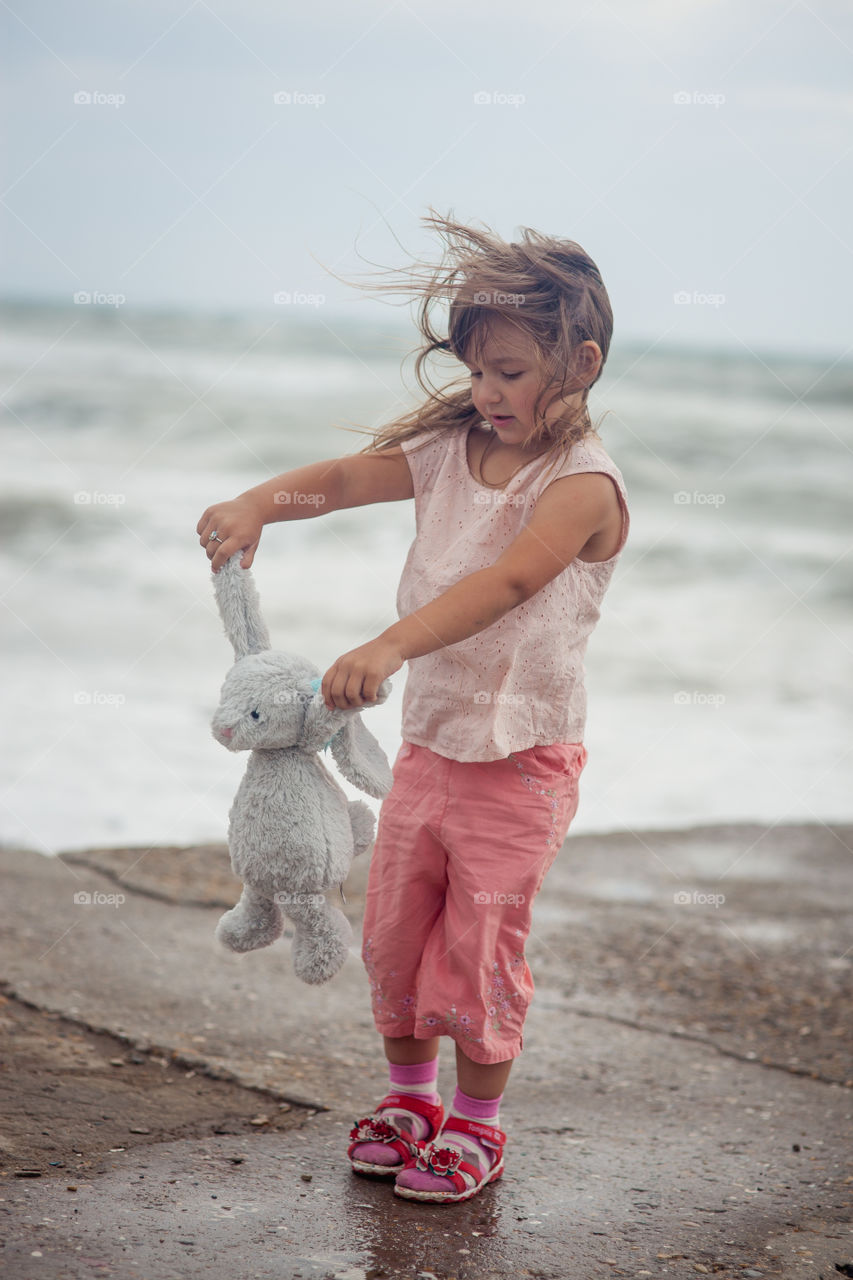 Girl portrait near sea a windy day