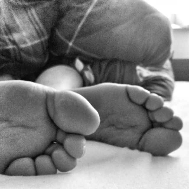 Closeup of bare feet in bed