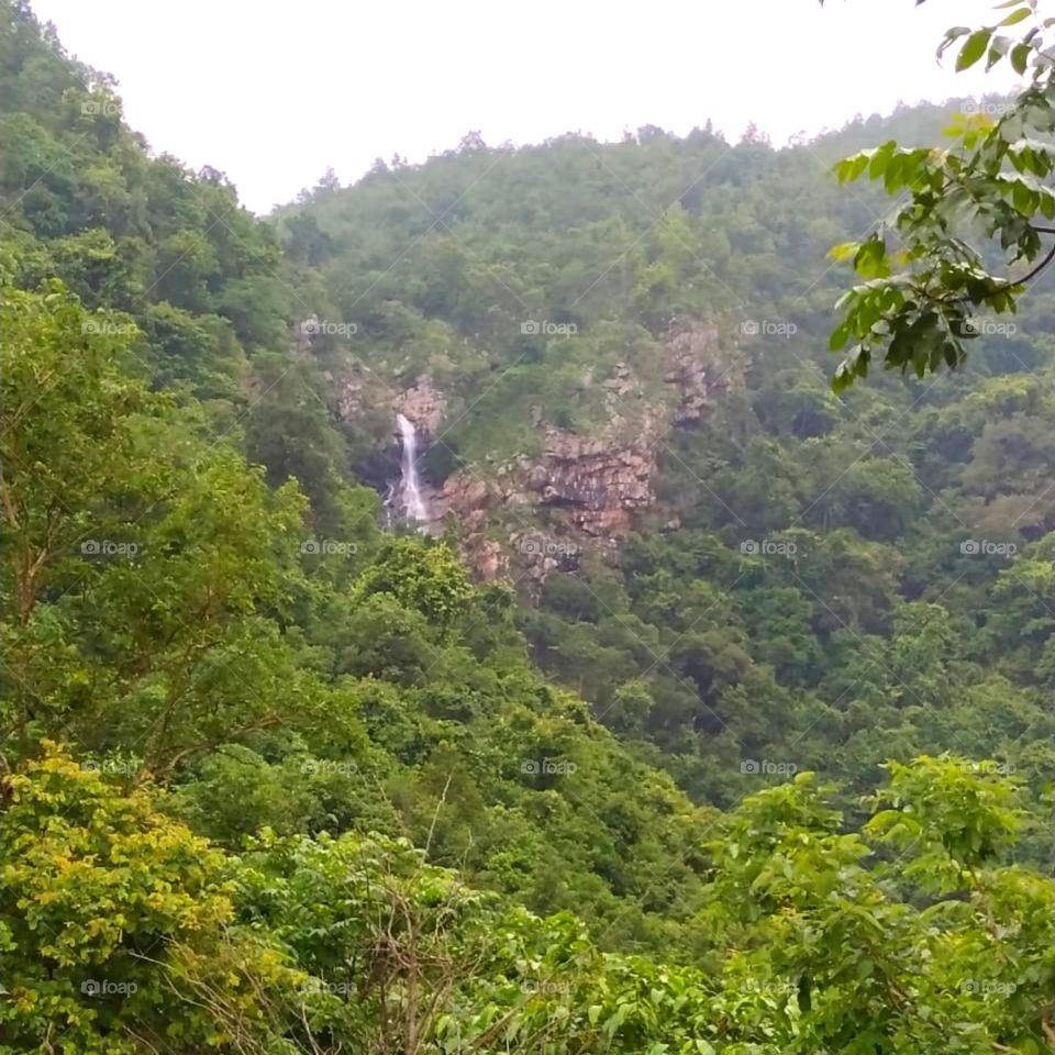 Beautiful view of waterfall falling from hills