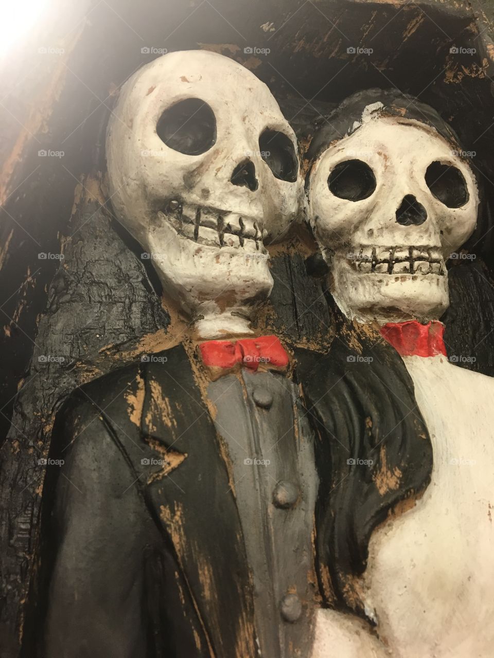 Haunted skeleton couple clinging to each other before being ripped apart to travel to the great beyond 