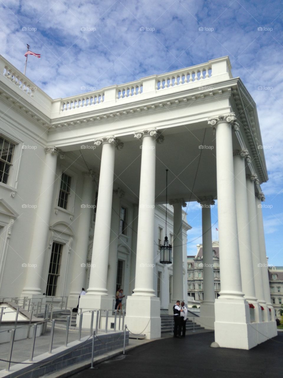 Side shot of the front of the White House. A Truly majestic peace of architecture. With a beautiful sky to covet it all. 