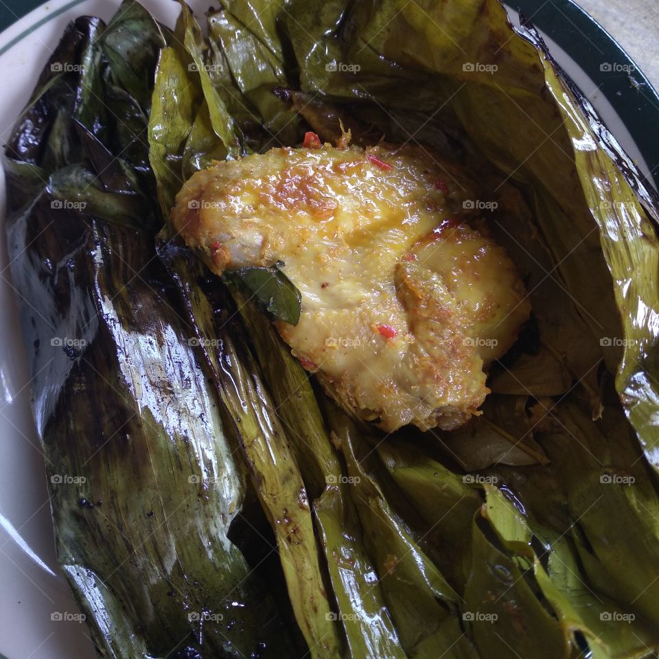 Steamed chicken wrapped in banana leaves