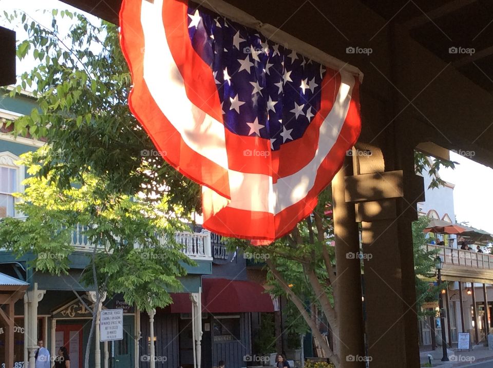 Historic Old Folsom, California, . USA bunting flag, late sun illuminating, in historic old Folsom, California